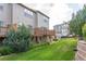 Lush backyard with a wooden deck and green lawn space, perfect for relaxation and outdoor enjoyment at 992 Burning Bush Pt, Monument, CO 80132
