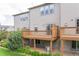Spacious backyard featuring a private wooden deck, mature landscaping, and room for outdoor activities at 992 Burning Bush Pt, Monument, CO 80132