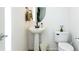 Contemporary bathroom boasts a pedestal sink and sleek black fixtures at 992 Burning Bush Pt, Monument, CO 80132