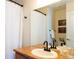 Bathroom featuring a granite-look vanity with dark fixtures and a shower with white curtain at 992 Burning Bush Pt, Monument, CO 80132
