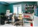 Eclectic green room showcasing a large window, study desks, and bookshelf at 992 Burning Bush Pt, Monument, CO 80132
