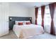 Bright bedroom with a comfortable bed, stylish headboard, and windows letting in plenty of natural light at 992 Burning Bush Pt, Monument, CO 80132