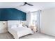 Stylish bedroom with a unique accent wall, comfortable bed, and a bright, airy ambiance for relaxation at 992 Burning Bush Pt, Monument, CO 80132