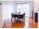 Elegant dining room features modern lighting, hardwood floors, and access to the backyard sliding door at 992 Burning Bush Pt, Monument, CO 80132