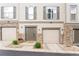 Charming townhome exterior featuring neutral siding, stone accents, attached garages and well-maintained landscaping at 992 Burning Bush Pt, Monument, CO 80132