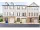 Attractive townhome featuring a neutral exterior with stone accents, well-kept lawns, and private garage at 992 Burning Bush Pt, Monument, CO 80132