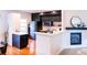 Contemporary kitchen with dark cabinets, stainless appliances, and a breakfast bar area at 992 Burning Bush Pt, Monument, CO 80132
