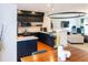 Modern kitchen features sleek black cabinetry, stainless steel appliances, and an open layout to the dining and living areas at 992 Burning Bush Pt, Monument, CO 80132