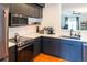Well-equipped kitchen with stainless steel appliances, dark cabinetry, subway tile backsplash and hardwood floor at 992 Burning Bush Pt, Monument, CO 80132