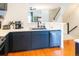 Stylish kitchen showcasing dark cabinets, stainless steel appliances, quartz countertop, and hardwood floors at 992 Burning Bush Pt, Monument, CO 80132