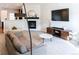 Cozy living room with a fireplace, entertainment center, and comfortable seating for relaxing and entertaining at 992 Burning Bush Pt, Monument, CO 80132