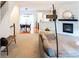 Open-concept living room featuring a fireplace, modern furnishings, and a seamless transition to the dining area at 992 Burning Bush Pt, Monument, CO 80132