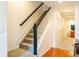 Carpeted staircase with wooden handrail leading to the upper level and nearby bathroom at 992 Burning Bush Pt, Monument, CO 80132