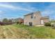 Large backyard features a well-maintained lawn, a sturdy wooden fence and a charming deck perfect for entertaining at 4369 E 127Th Way, Thornton, CO 80241