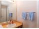 Bright bathroom featuring a large mirror, modern sink, and practical towel racks for a clean look at 4369 E 127Th Way, Thornton, CO 80241