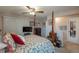 Cozy bedroom featuring a floral bedspread, ceiling fan, and a television for comfortable relaxation at 4369 E 127Th Way, Thornton, CO 80241