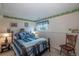 Serene bedroom with a decorative border, iron bed frame, and soft blue bedding for a relaxing atmosphere at 4369 E 127Th Way, Thornton, CO 80241