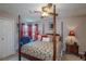 Comfortable bedroom with a four-poster bed, ceiling fan, and soft natural light at 4369 E 127Th Way, Thornton, CO 80241