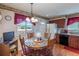 Cozy dining area features wooden table with seating for four and a view to the backyard at 4369 E 127Th Way, Thornton, CO 80241