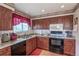 Well-lit kitchen features wooden cabinets, granite counters, and modern appliances at 4369 E 127Th Way, Thornton, CO 80241
