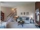 Inviting living room with staircase, comfortable seating, and large window at 4369 E 127Th Way, Thornton, CO 80241