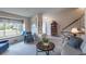 Bright living room features large windows, neutral paint, and staircase at 4369 E 127Th Way, Thornton, CO 80241