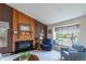 Cozy living room with wood-burning fireplace, large window, and natural light at 4369 E 127Th Way, Thornton, CO 80241