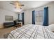 Spacious bedroom with large bed, natural light, and a desk area for work or study at 15476 W 64Th Loop # C, Arvada, CO 80007