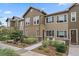 Well-maintained townhome exterior with landscaping and a sidewalk at 15476 W 64Th Loop # C, Arvada, CO 80007