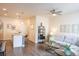 Comfortable living room featuring modern furniture, a ceiling fan, and a stylish breakfast bar at 15476 W 64Th Loop # C, Arvada, CO 80007