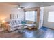 Cozy living room with a comfortable sectional sofa, natural light, and modern decor elements at 15476 W 64Th Loop # C, Arvada, CO 80007