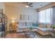 Bright living room features a sectional sofa, stylish shelving, and natural light from a large window at 15476 W 64Th Loop # C, Arvada, CO 80007