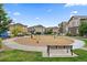 Community playground with swings and seating surrounded by multi-Gathering homes and green spaces at 15476 W 64Th Loop # C, Arvada, CO 80007