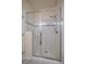Modern shower with glass door, seat, and decorative tile at 15476 W 64Th Loop # C, Arvada, CO 80007