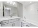 Modern bathroom features a sleek vanity, mirror, and tub with white subway tile surround at 8846 Yates Dr, Westminster, CO 80031