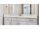 Bathroom vanity with white cabinetry, marbled countertop, and modern fixtures at 8846 Yates Dr, Westminster, CO 80031