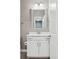 Well-lit powder room featuring modern vanity with marble top and mirror at 8846 Yates Dr, Westminster, CO 80031