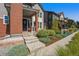 Charming two-story home features a brick accent wall, covered porch, and professionally landscaped front yard at 8846 Yates Dr, Westminster, CO 80031