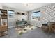 Bright home office with modern desk, accent wall, shelving and chair at 8846 Yates Dr, Westminster, CO 80031