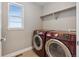 Well-equipped laundry room with modern washer and dryer and storage shelves at 8846 Yates Dr, Westminster, CO 80031