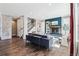 Bright living room with hardwood floors, fireplace, custom shelving and a staircase with white risers at 8846 Yates Dr, Westminster, CO 80031