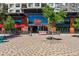 The restaurant's welcoming facade features red umbrellas, large windows, and patio seating at 8846 Yates Dr, Westminster, CO 80031