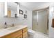 Bright bathroom featuring a walk-in shower, vanity, and clean finishes at 7583 W Trail South Dr, Littleton, CO 80125