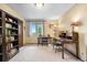 Bedroom converted into a study with two writing desks and a wall of bookshelves at 7583 W Trail South Dr, Littleton, CO 80125