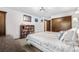 Bedroom with a bookcase and a closet with wood doors next to a bed covered with a patterned comforter at 7583 W Trail South Dr, Littleton, CO 80125