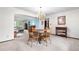 Open-concept dining room with chandelier, seamlessly connected to the inviting living room at 7583 W Trail South Dr, Littleton, CO 80125