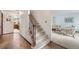 Inviting foyer with a staircase, leading to a living room featuring neutral tones and comfortable seating at 7583 W Trail South Dr, Littleton, CO 80125