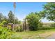 Landscaped front yard with a gated fence and green lawn at 7583 W Trail South Dr, Littleton, CO 80125