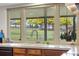 Close-up of a kitchen sink with a window offering an unobstructed view of the lush green backyard at 7583 W Trail South Dr, Littleton, CO 80125