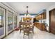 Charming eat-in kitchen with wood cabinets, breakfast nook, and sliding doors to the outdoor patio at 7583 W Trail South Dr, Littleton, CO 80125